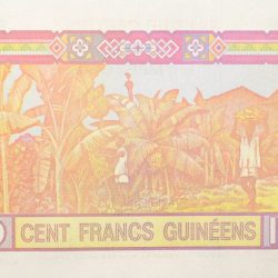100 Francs of Guinea Country (AD 1998) with Peasant work scene in a plantation of bananas, with people harvesting fruits